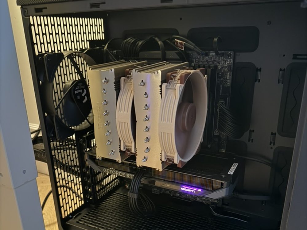 Inside the case: a large twin-tower air cooler with three fans filling the middle of the machine, the graphics card mounted beneath it, and the power supply shrouded along the bottom